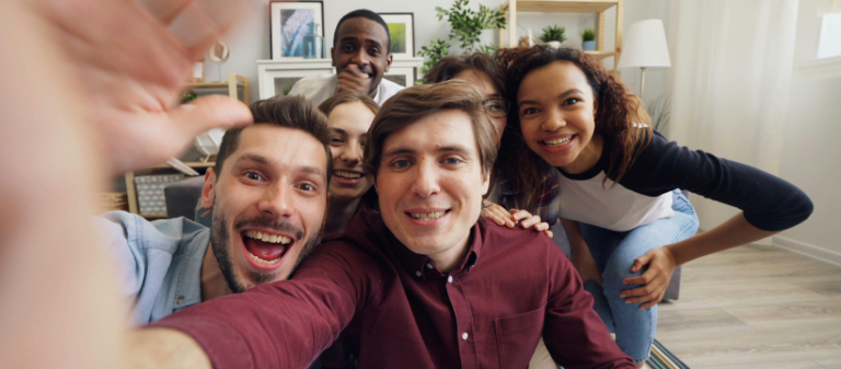 Group of diverse men and women smiling at the camera – representing people embracing life’s journey, including the lessons learned through failure