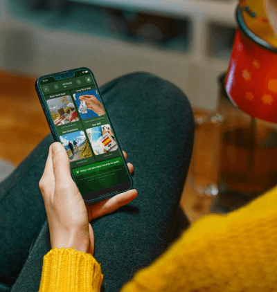 Man listening with headphones while using the Pocket Power psychology-driven programme on his phone, showing the guided pathway and audio tools for habit change